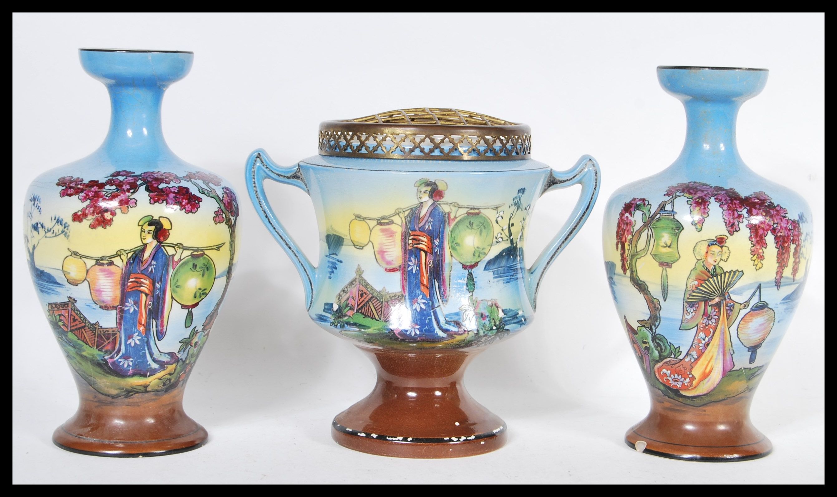 A pair of early 20th Century hand painted garniture vases and matching centerpiece, each piece