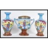 A pair of early 20th Century hand painted garniture vases and matching centerpiece, each piece
