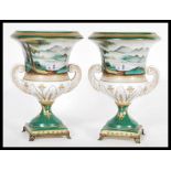 A pair of Continental German urn vases in the manner of Meissen raised on square bases with brass