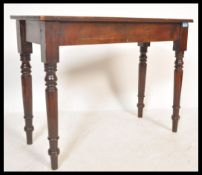 A Victorian 19th century mahogany writing table desk being raised on turned legs with fitted