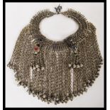 An early 20th Century silver white metal ladies headdress having glass bead stone decoration with