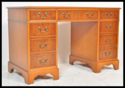 A 20th Century antique style reproduction twin pedestal desk having mahogany veneer. Two banks of