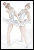 A Lladro ceramic figurine group of Ballerinas entitled Ballet Dress Rehearsal model 05497 complete