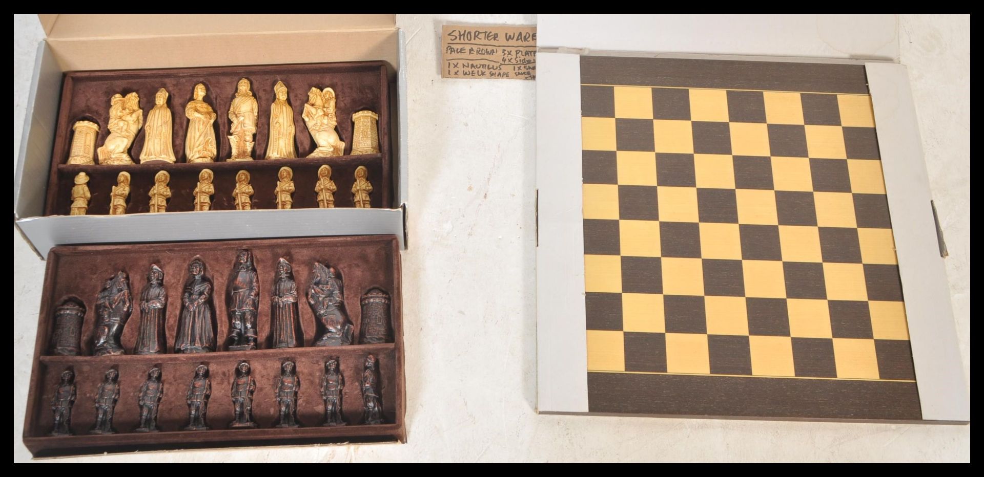 A vintage boxed SAC chess set having ebonised and faux ivory pieces in the medieval style.
