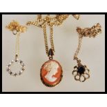 A group of three 9ct gold pendants comprising of a large faceted garnet set pendant on 9ct gold