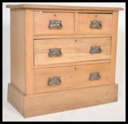 A 20th Century stripped walnut cottage chest of two over two chest of drawers having swing