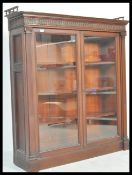 A 19th Century Victorian mahogany glazed bookcase with adjustable dogs tooth shelving, full length