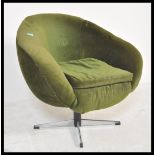 A vintage retro 20th Century circa 1960's swivel egg chair upholstered in green velour material