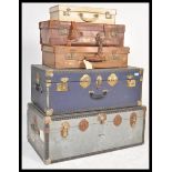 A collection of vintage and retro 20th Century trunks and suitcases, to include two steamer