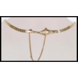 A stamped 9ct gold Art Deco Ouroboros choker necklace in the form of a serpent / snake having a flat