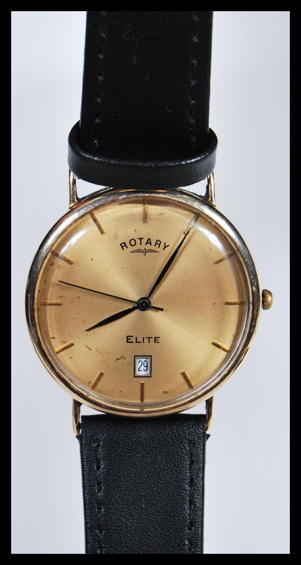 A 9k 9ct gold Rotary Elite gents watch having a champagne dial with glt baton numerals and faceted