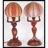 A pair of fantastic retro 1950's - mid 20th Century teak bedside table lamps, the lamps modeled as