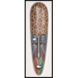 A large 20th Century Australian Aboriginal carved tribal wall mask having detailed features and