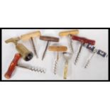 A collection of eight antique and vintage corkscrews to include an Art Deco nude bottle opener,