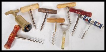 A collection of eight antique and vintage corkscrews to include an Art Deco nude bottle opener,