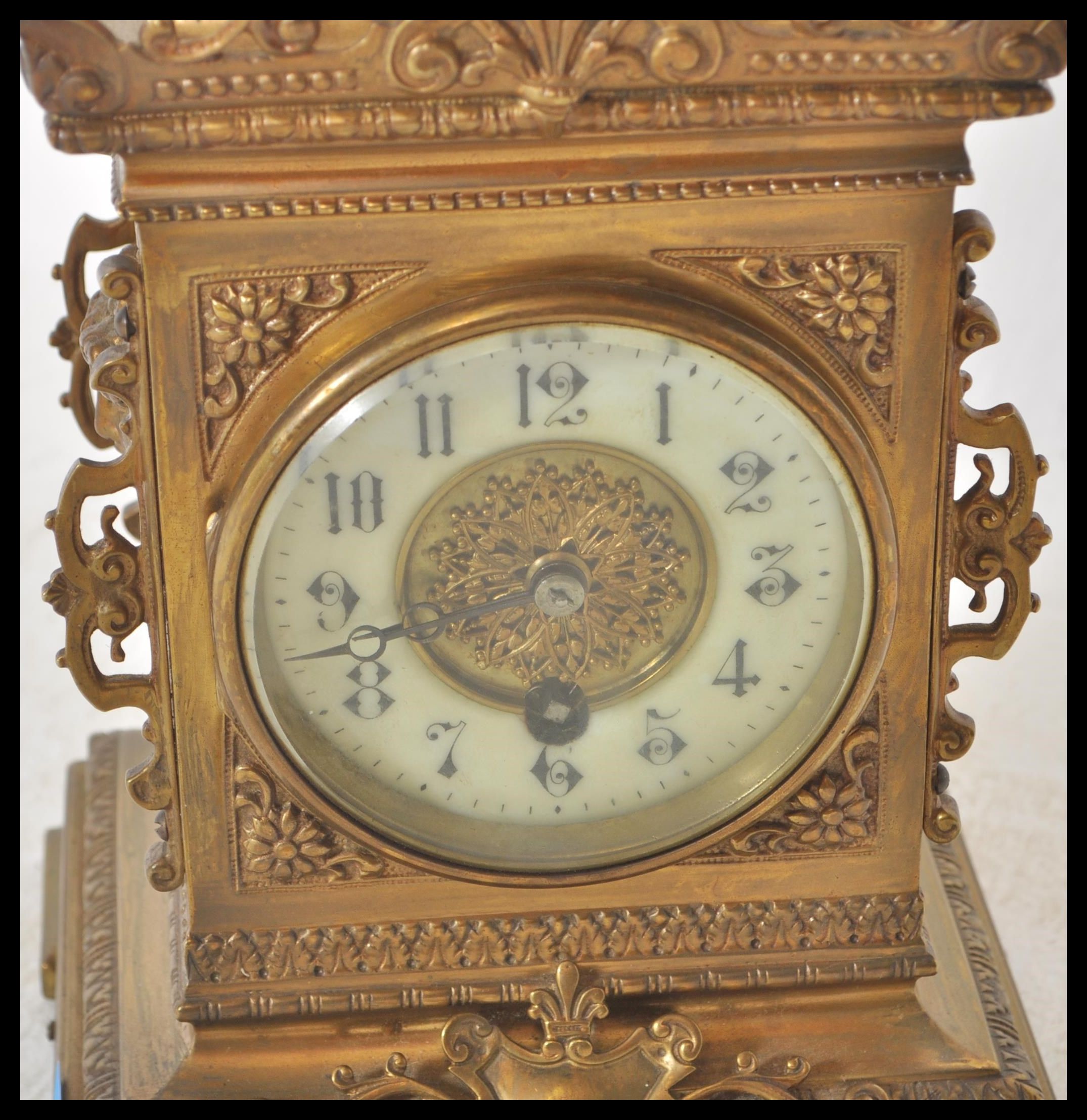 A 19th Century Victorian gilt brass mantel clock raised on a bracket base with armorial decoration - Image 3 of 6