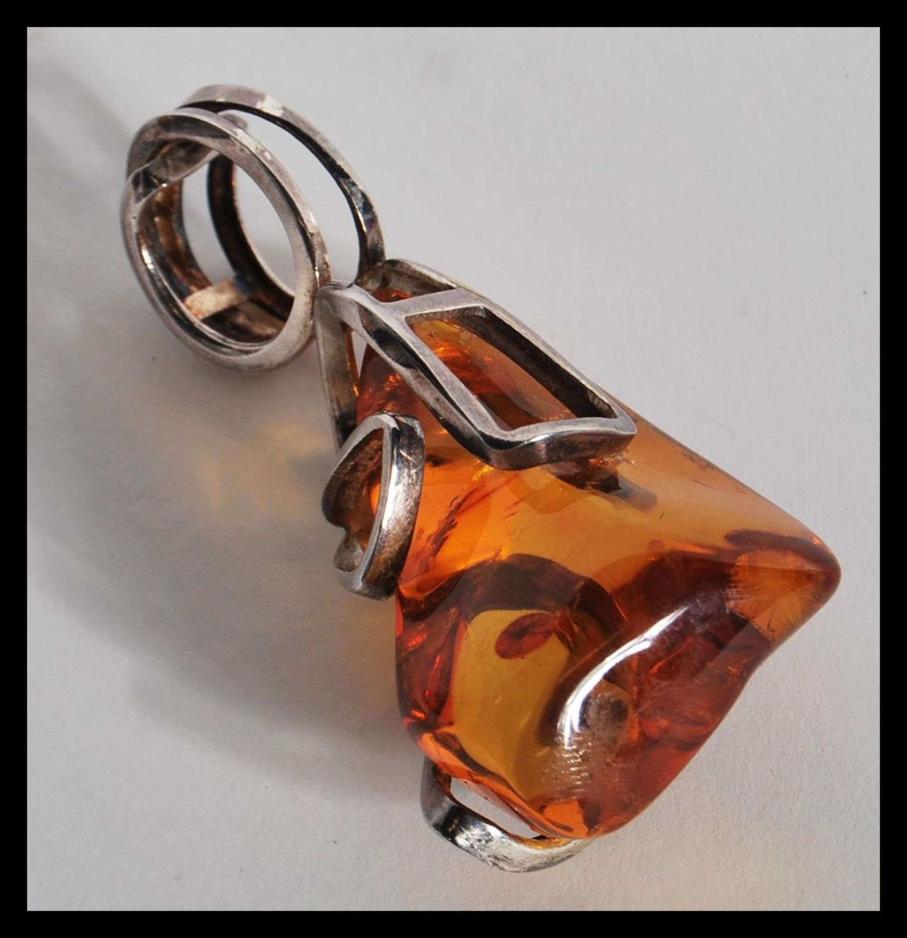 A vintage large amber necklace pendant having a sterling silver 925 necklace mount. Total weight