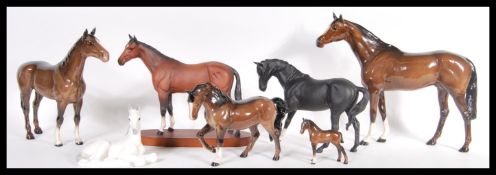 A collection of seven ceramic horses to include Royal Doulton, USSR and Beswick examples, varying in