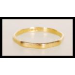 A 22ct gold Birmingham hallmarked octagonal band ring. Total weight 2.6g / Size X