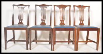 A set of four early 20th Century mahogany dining chairs having fan back rests with drop in seats