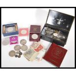 A collection of coins dating from the 19th Century to include coins and notes from all around the