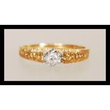 A hallmarked 18ct gold diamond single stone solitaire ring having bark effect band and shoulders