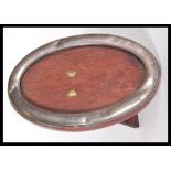 A silver hallmarked mahogany backed easel mirror of oval form, Chester assay mark with rubbed makers