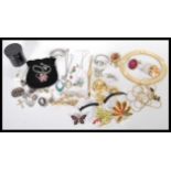 A collection of vintage silver and costume jewellery to include silver thimble, figural brooches