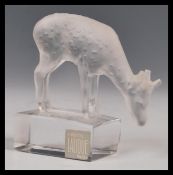 A Lalique frosted glass paperweight with standing deer figurine Signed to base with original label