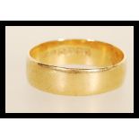 A hallmarked 18ct gold wedding band ring. Hallmarked Birmingham 1921. Weight 4.8g. Size V.