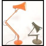A pair of vintage retro 20th Century anglepoise industrial desk lamps raised on circular bases