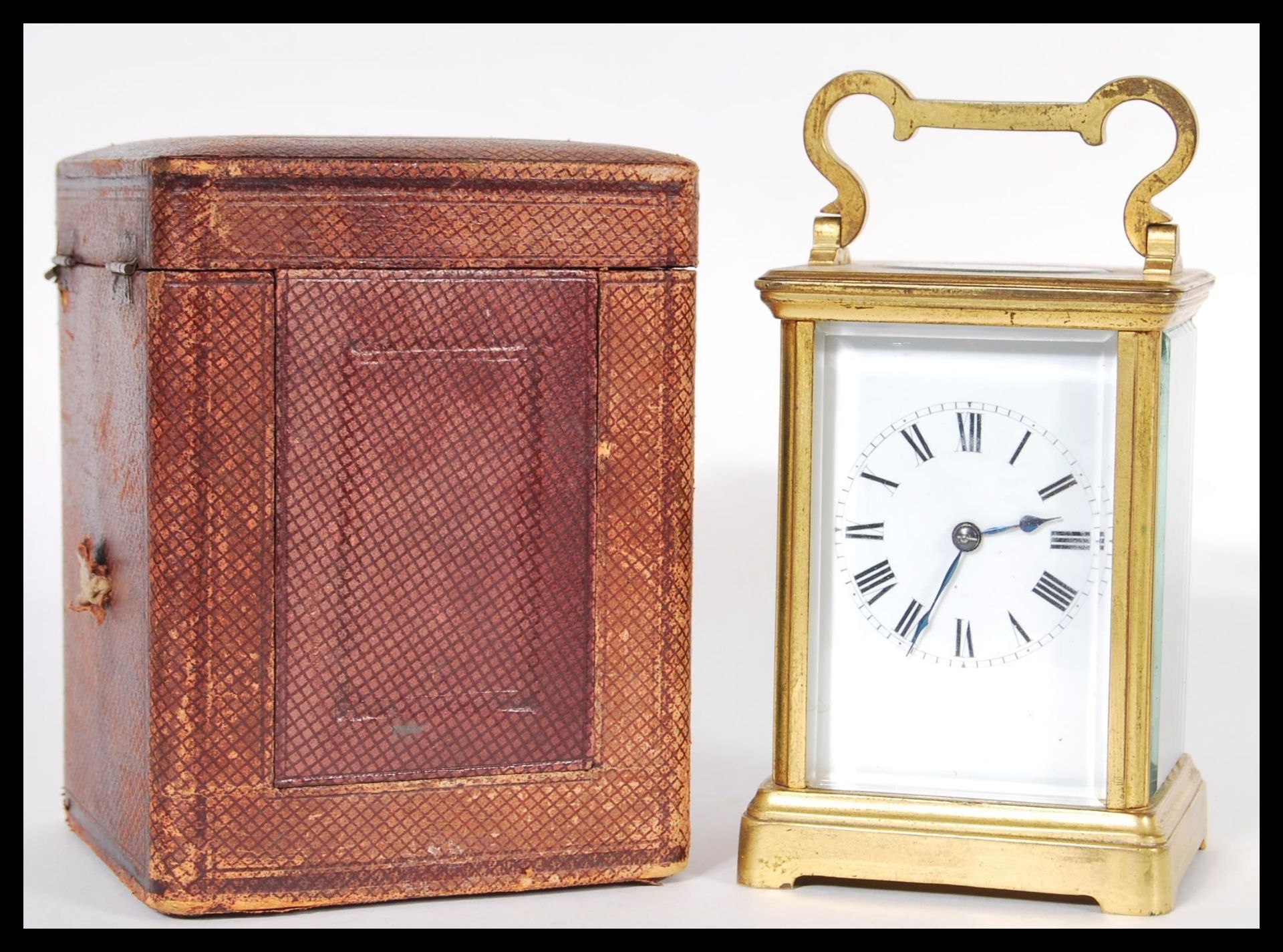 A 19th Century Victorian French gilt brass carriage clock having a white enamel face with Roman