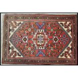 A 20th Century Persian carpet floor rug having a red ground with central tree of life panel and