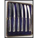 A set of six 20th Century hallmarked silver knives complete in fitted faux black leather case.