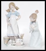 Two Lladro figurines to include ' Playful Kittens ' depicting a girl cleaning with three kittens,