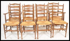 A set of 8 early 20th century beech wood country ladderback dining chairs being raised on turned