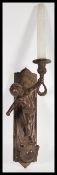 A 19th Century bronze figural wall sconce in the form of a cherub putti raisedon armorial stand with
