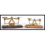 Two sets of late 19th / early 20th Century postal scales. One in brass and one in bronze both