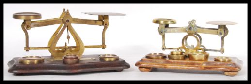 Two sets of late 19th / early 20th Century postal scales. One in brass and one in bronze both