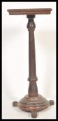 A 19th Century pedestal Torchere / plant stand having a square top having a moulded edge raised on a