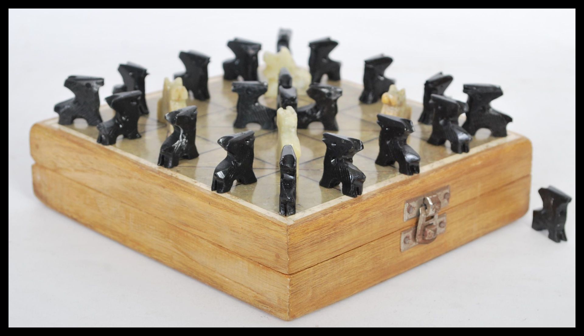 A vintage game of Bagh Chal or Tigers and Goats game complete in fitted box with stone inlay grid