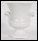A vintage 20th century cream glazed pottery plant vase / table centerpiece of smaller form,