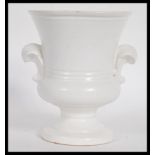 A vintage 20th century cream glazed pottery plant vase / table centerpiece of smaller form,