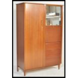 A retro mid 20th Century teak wood compactum / bachelors wardrobe,  full length door to the left