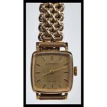 A vintage Garrard 9ct gold ladies watch set to a 9ct gold cross mesh link watch bracelet strap.