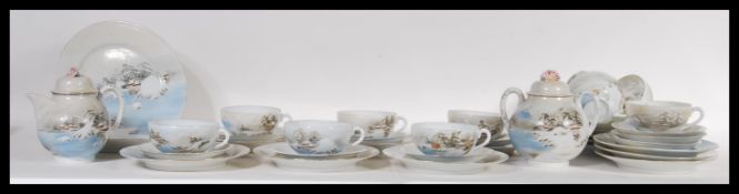 An early 20th Century Japanese Kutani ware eggshell porcelain tea service consisting of ten cups