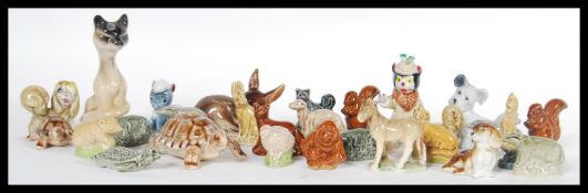 A collection of Wade Whimsy ceramic figurines to include two graduating tortoises, a pegasus