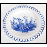 A 19th Century transfer printed blue and white pearlware ribbon plate having a central cartouche
