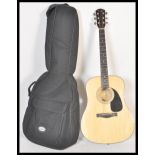 A 20th Century Fender six string acoustic guitar model DG-5 NAT having a shaped hollow body with