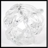 A 20th Century retro studio art glass sculpture in the form of a knot. The sculpture of clear